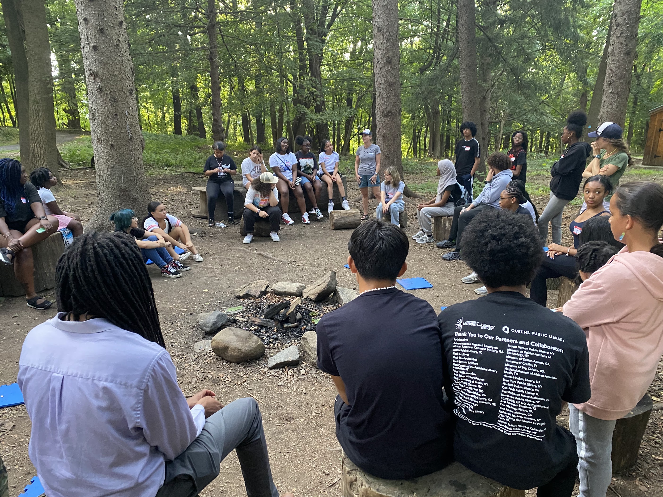 A diverse group of Wayfinders participants gathered together outdoors